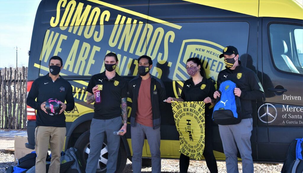 5 zuni staff members standing in front of New Mexico united van